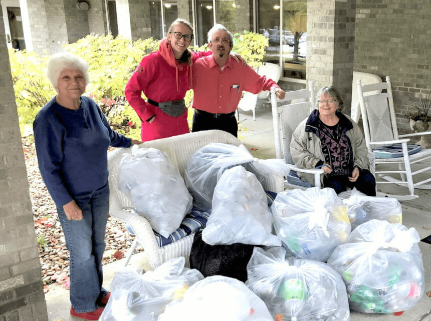 People standing by bags of donations.