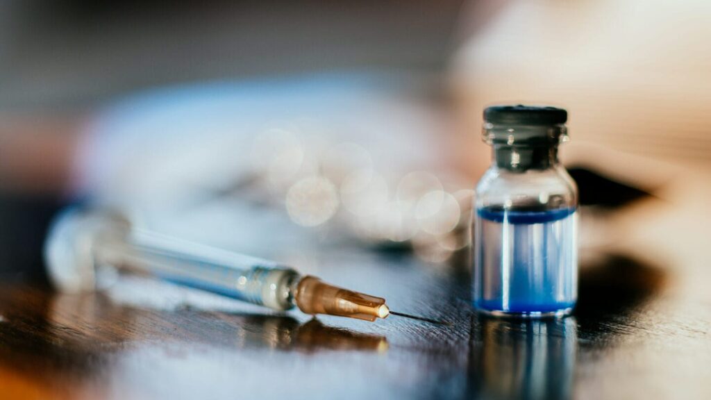 Syringe and a vial on a table
