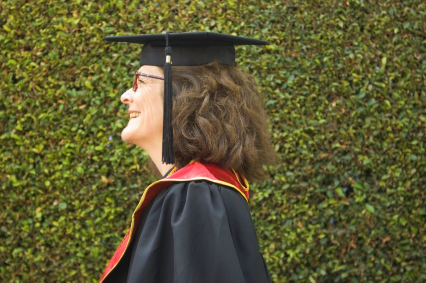 older adult in graduation garb