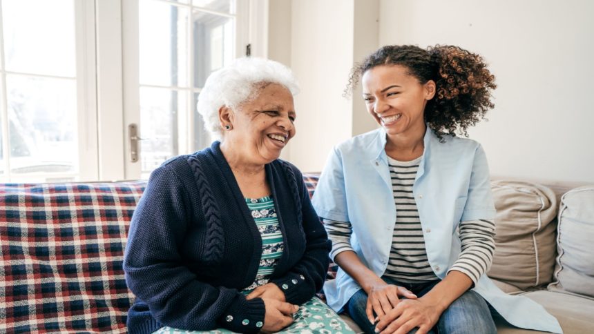 Caretaker and patient smiling at one another