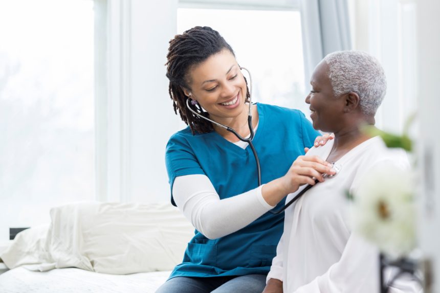 Female nurse checks patient's vital signs