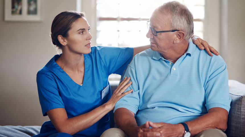 female healthcare worker comforting older man
