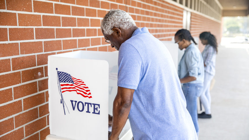 Three African American people voting in an election