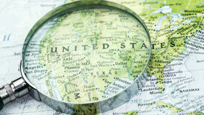 A shot of magnifier glass over map. Looking, searching, research information and traveling