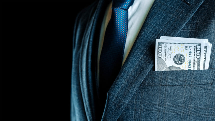 closeup of $100 bills in suit coat pocket