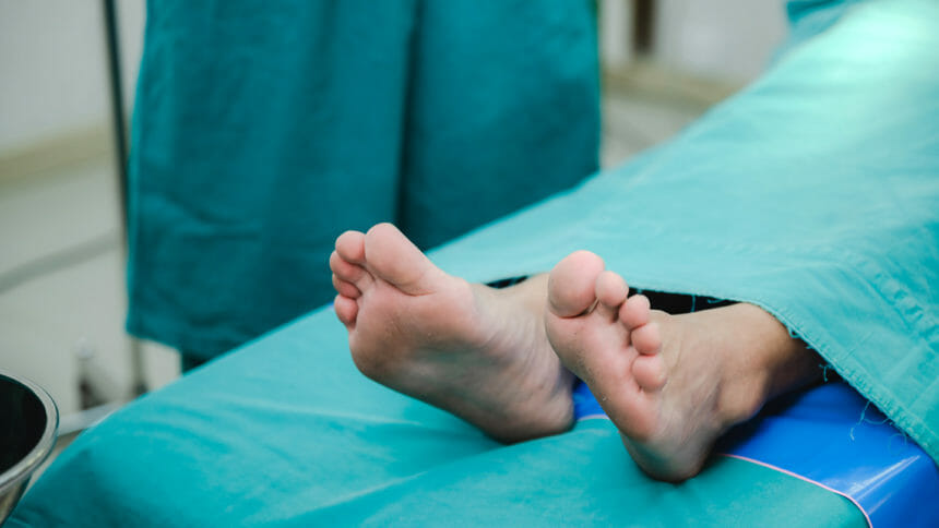 corpse foot on hospital table, health care medicine concept and life death insurance business