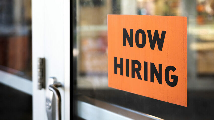 door with now hiring sign on it