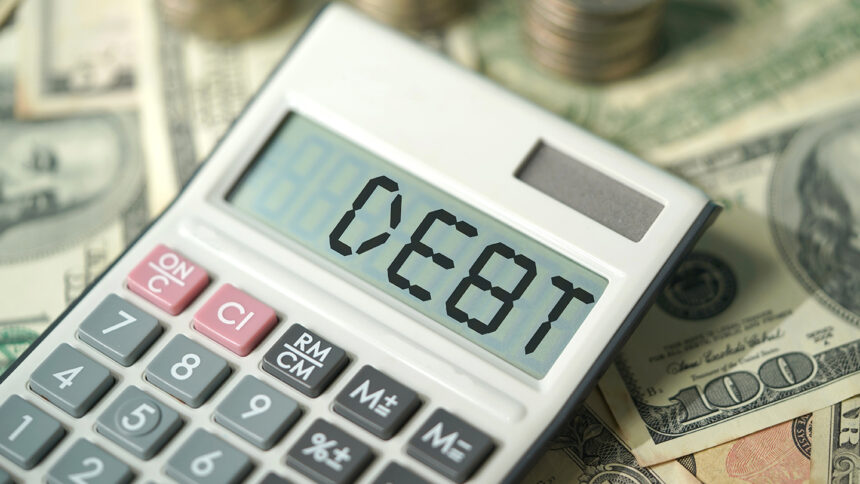 DEBT , calculator and american dollar with coins, financial concept photo