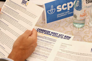 Closeup of hands holding papers at Senior Care Pharmacy Coalition campaign launch