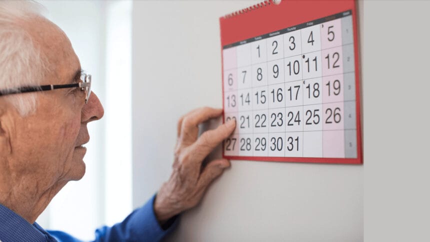 older man looking at calendar