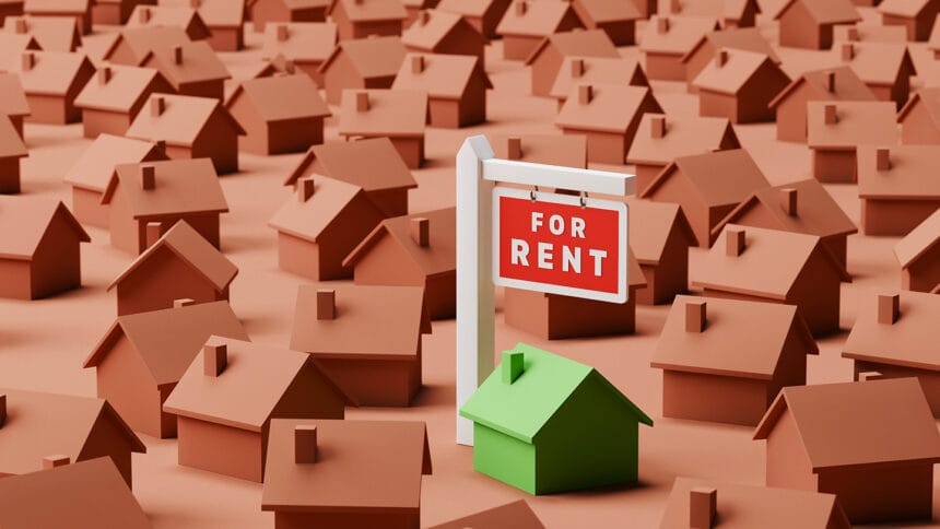 Conceptual image of a single green house amongst many brown ones with a for rent sign. Rental market concept