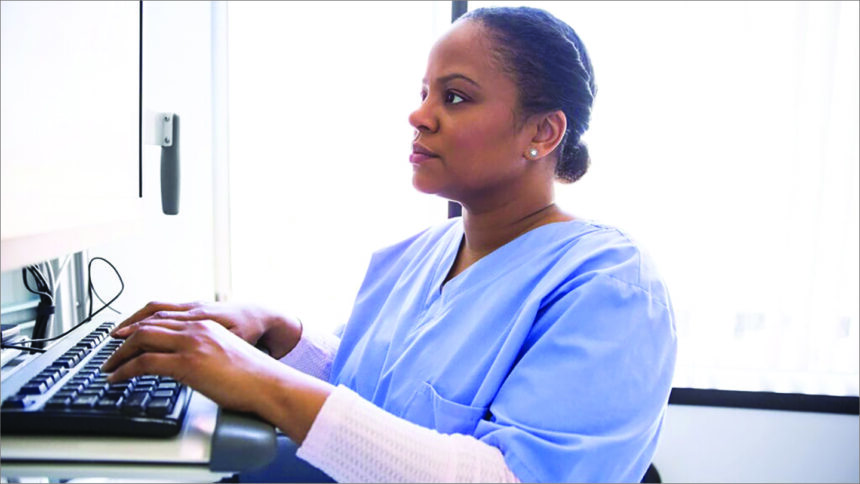 healthcare worker at keyboard