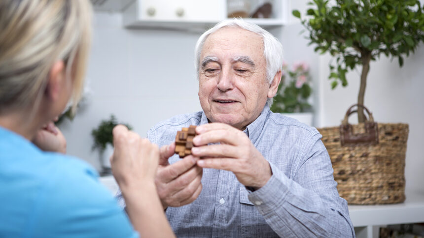 Gereatric nurse doing dexterity games with elderly patient