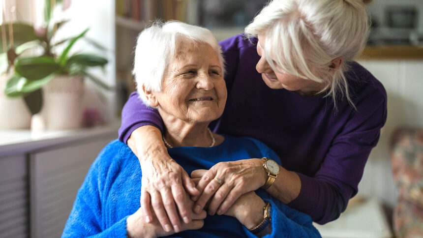 Woman hugging her elderly mother