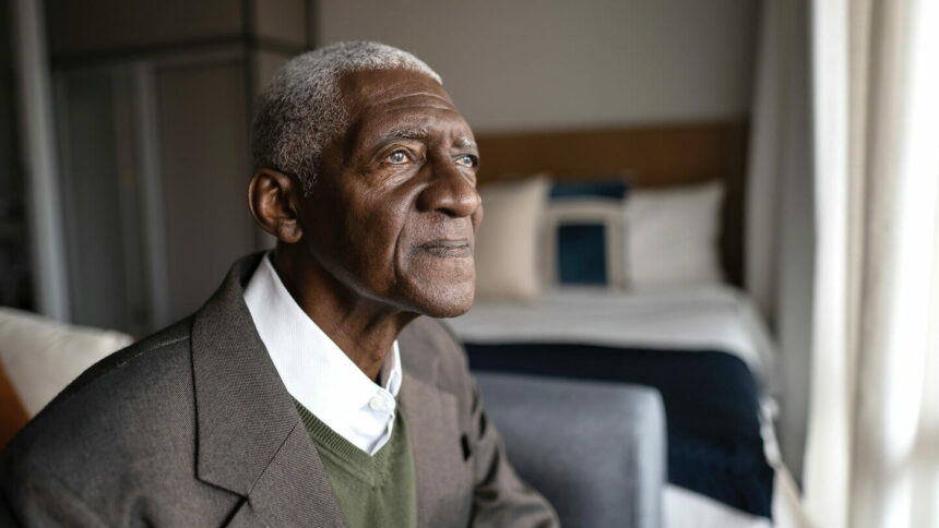 Black older man staring off into space