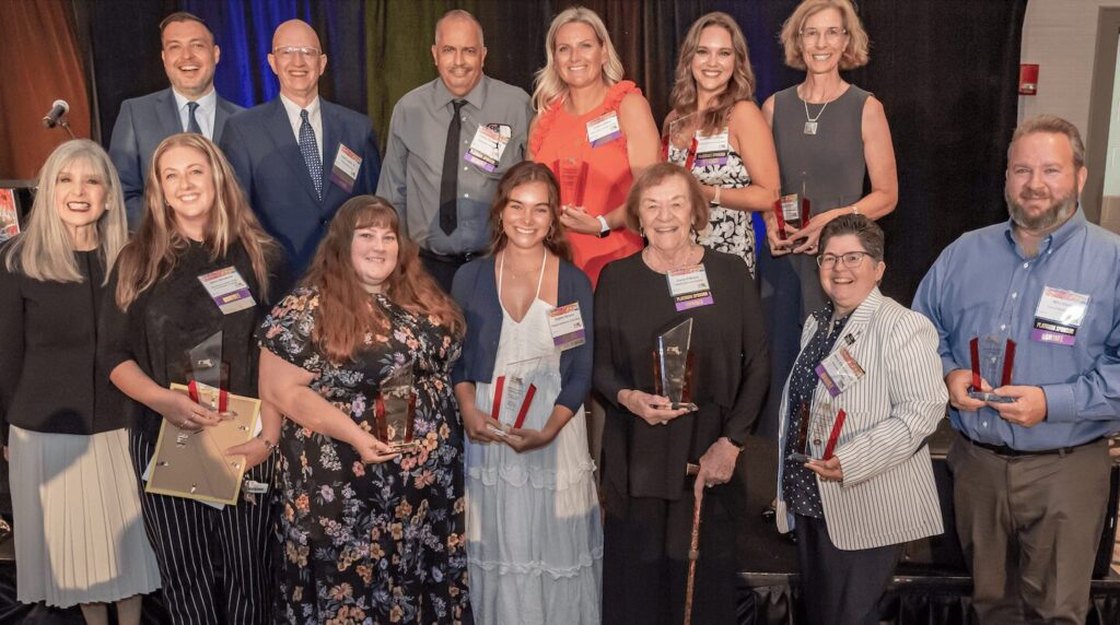 group of people holding awards