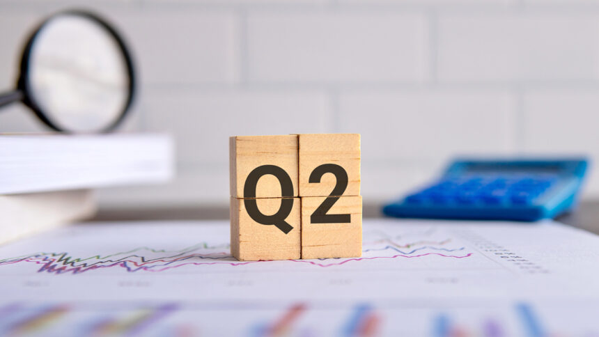 Close up image of wooden cubes with alphabet Q2 on office desk. Second quarter concept.