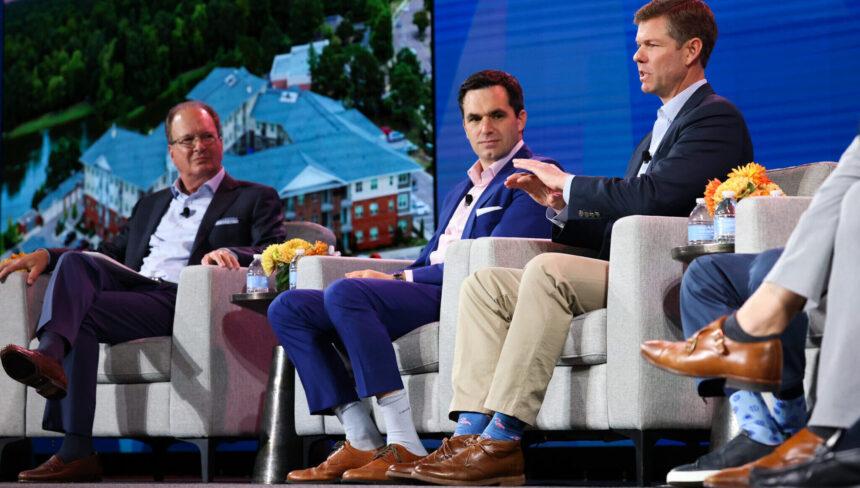 Men in chairs on a stage