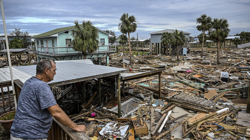 TOPSHOT - David Hester inspects damages of his house after Hurricane Helene made landfall in Horseshoe Beach, Florida, on September 28, 2024. At least 44 people died across five US states battered by powerful storm Helene, authorities said on September 27, after torrential flooding prompted emergency responders to launch massive rescue operations. (Photo by CHANDAN KHANNA / AFP) (Photo by CHANDAN KHANNA/AFP via Getty Images)