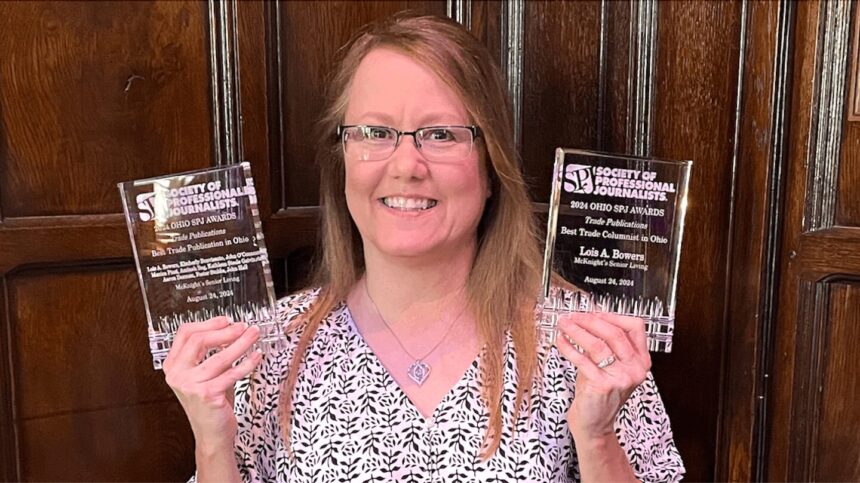 Lois Bowers poses with two awards