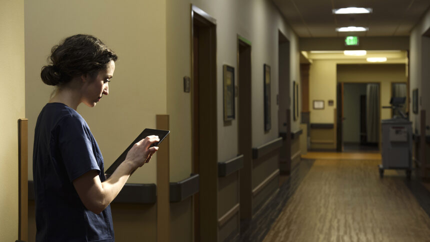 Nurse using digital tablet in hospital