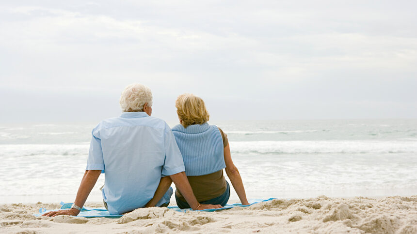 Senior couple sitting on a beach