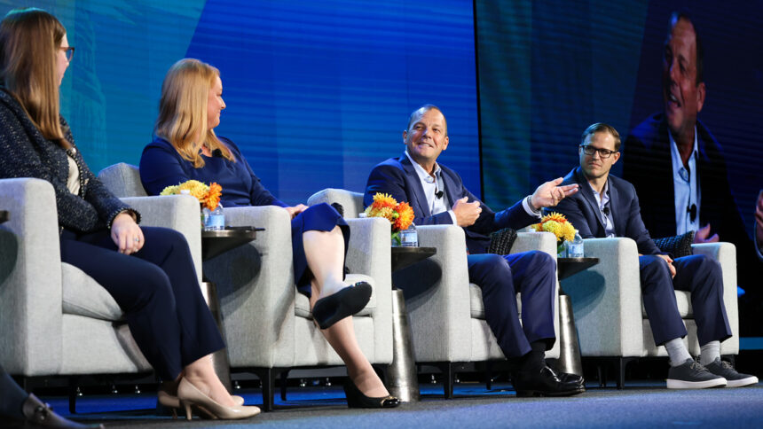 people sitting in chairs on a stage