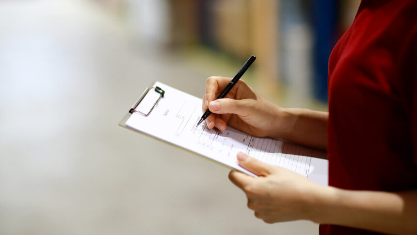 Warehouse worker taking inventory in logistics warehouse