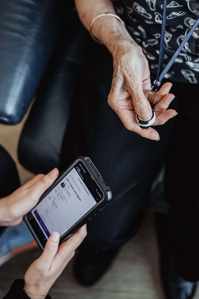 hand pushing button. other hands looking at smartphone