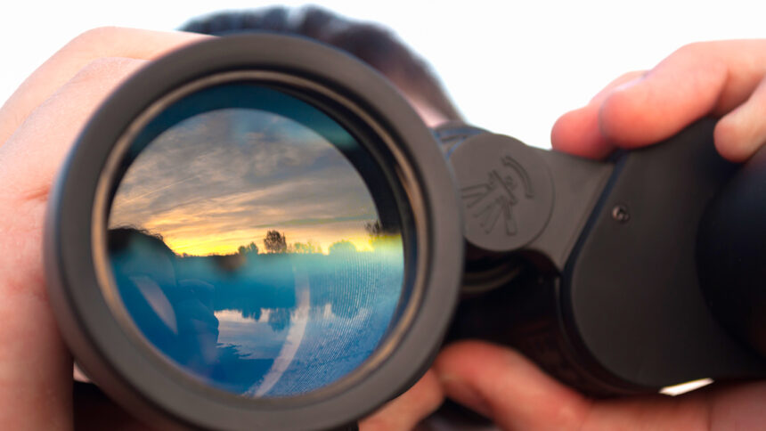 a man looking through binoculars