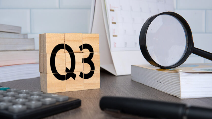 Close up image of wooden cubes with alphabet Q3 on office desk. Third quarter concept.