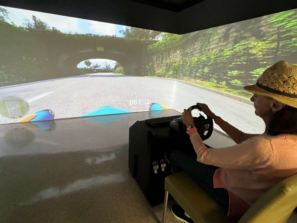 person in VR simulator, "driving"