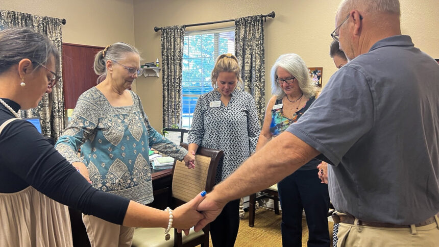 Wildwood Senior Living residents hold hands in a circle